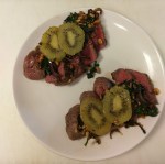 Rare center cut sirloin topped with sauteed spinach, walnuts, and onions served with caramelized kiwi